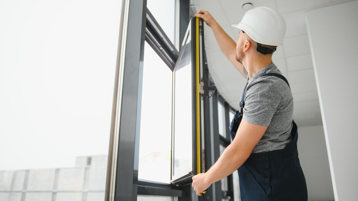 construction-worker-repairing-plastic-window-with-screwdriver-indoors-space-text-banner-design-5-scaled.jpg